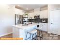 Modern kitchen with stainless steel appliances, white cabinetry, and sleek quartz countertops at 6336 Busch Ave, Midland, NC 28107