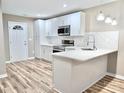 Beautiful kitchen with white cabinetry, marble countertops, stainless appliances and eat-in island at 6756 Denver Heights Cir, Denver, NC 28037