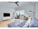 Cozy living room with modern furniture, a ceiling fan, and natural light at 715 N Church St, Charlotte, NC 28202