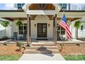 Charming front porch with brick steps, rocking chairs, and a view of the American flag at 722 Clegg Farm Dr, York, SC 29745