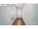 Bright entryway featuring hardwood floors, a glass front door, and French doors at 7729 Woolsey Dr, Gastonia, NC 28056