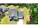 This aerial shot displays a lovely home, well-manicured lawn, and driveway for easy access at 8701 W Dixie Dr, Charlotte, NC 28278
