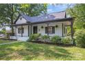 Charming home featuring a covered front porch, fresh landscaping, and light exterior at 118 Cabarrus W Ave, Concord, NC 28025