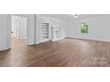 Bright, neutral living room featuring new floors, fresh paint, built-in shelving and a window at 118 Cabarrus W Ave, Concord, NC 28025