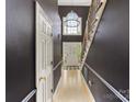 View of the home's entryway with a hardwood floor, a staircase, and a hanging chandelier at 15313 Moate Ct, Huntersville, NC 28078