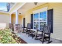 Inviting front porch with rocking chairs, perfect for enjoying the outdoors and relaxing at 1618 Bay Meadows Nw Ave, Concord, NC 28027