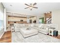 Open-concept living room with a large sectional couch, leading into a modern kitchen at 1618 Bay Meadows Nw Ave, Concord, NC 28027