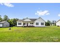 Traditional ranch home with a well-maintained lawn, front porch, American flag, and classic design at 170 Wagon Wheel Way # 4, Salisbury, NC 28147