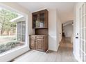 Bright dining area featuring built-in cabinets and a large window overlooking the serene backyard at 1770 Windsor Dr, Lancaster, SC 29720