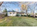 View of the side of a house with a well-maintained lawn and mature trees, offering a peaceful setting at 1770 Windsor Dr, Lancaster, SC 29720