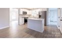 Modern kitchen featuring a center island, stainless steel appliances, and seamless flow to living area at 1770 Windsor Dr, Lancaster, SC 29720