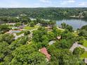 Stunning aerial view of a lakeside community surrounded by lush green trees and mountains in the distance at 2045 10Th Street Nw Ln, Hickory, NC 28601