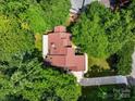 Aerial view of a home with mature trees, a long driveway, and a brown shingled roof at 2045 10Th Street Nw Ln, Hickory, NC 28601