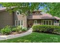 Charming two-story home features a manicured lawn, stone accents, and lush landscaping at 2045 10Th Street Nw Ln, Hickory, NC 28601