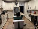 Spacious kitchen with white cabinets, granite countertops, and a center island, perfect for cooking and entertaining at 208 Stone Ridge Dr, Salisbury, NC 28146
