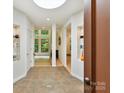 Inviting foyer featuring neutral tile flooring, recessed lighting, and seamless transition into the living spaces at 218 Point Carpenter Rd, Fort Mill, SC 29707