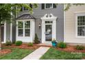 Welcoming front entrance featuring a decorative door frame, well-maintained landscaping, and inviting curb appeal at 2444 Mariners Cove Ln, Denver, NC 28037