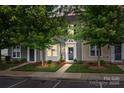 Charming townhouse showcasing meticulously manicured landscaping framing the entrance, set on a cozy lot at 2444 Mariners Cove Ln, Denver, NC 28037