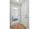 Bright hallway leading to a bedroom with neutral décor and wood-look flooring at 317 Cedarcroft Dr, Mooresville, NC 28115