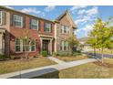 Charming brick townhome showcasing its inviting entrance and well-maintained lawn at 3436 Scottish Fern Ln # 172, Indian Land, SC 29707