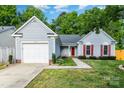 Charming single-Gathering home featuring a one car garage, red shutters and door, and a well-manicured lawn at 3505 Frostmoor Pl, Charlotte, NC 28269