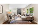 Inviting living room featuring a cozy fireplace, stylish furniture, and ample natural light at 3661 Annlin Ave, Charlotte, NC 28209