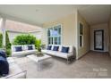 Inviting covered patio with comfortable seating, stylish decor, and a relaxing outdoor ambiance at 467 Granite Lake Ct, Denver, NC 28037