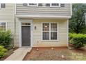 Close-up view of townhome entrance, showing door and adjacent window detail at 5529 Seths Dr, Charlotte, NC 28269