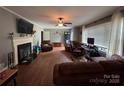 Cozy living room with fireplace, hardwood floors, and neutral walls at 616 E Oakwood Ave, Albemarle, NC 28001