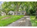 A charming single-story home with a spacious driveway and beautiful lawn at 6749 Windyrush Rd, Charlotte, NC 28226