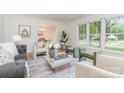 Bright living room featuring hardwood floors, a large window, and stylish furniture at 6749 Windyrush Rd, Charlotte, NC 28226
