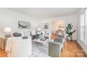 Bright living room with hardwood floors, stylish decor, and an open doorway at 6749 Windyrush Rd, Charlotte, NC 28226