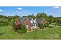 Well-kept brick home features lush landscaping and inviting curb appeal at 814 Settlers Dr, Cherryville, NC 28021