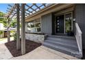 Close-up of modern front door and a stone accent wall for added curb appeal at 917 Dent Ct, Charlotte, NC 28210
