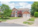 Beautiful brick home featuring a manicured lawn and two-car garage at 9710 Holden Ct, Charlotte, NC 28277
