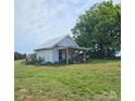 Quaint outbuilding on a grassy lot with a covered porch and various equipment, plus a large tree at Tbd Jerusalem Church Rd, Marshville, NC 28103
