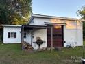 Spacious detached garage with a large roll-up door, and covered porch at 1014 Skyway Dr, Kannapolis, NC 28083