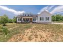 Charming two-story farmhouse style home featuring a welcoming front porch and dormer windows at 1134 Fincher Rd, Fort Lawn, SC 29714