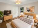 Cozy bedroom with light wood accents, a large window, and ample natural light, virtually staged at 1212 Beechdale Dr, Charlotte, NC 28212