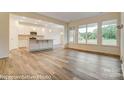 Open-concept kitchen featuring white cabinets, stainless appliances, and a kitchen island at 125 S Prestwick Way # 41, Mooresville, NC 28115