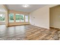 Bright living room with large windows overlooking backyard and new laminate flooring throughout at 125 S Prestwick Way # 41, Mooresville, NC 28115