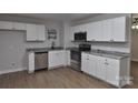 This kitchen features wooden floors, stainless steel appliances, and a granite countertop at 1277 Eden Dr # 18, Chester, SC 29706