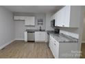 This kitchen features wooden floors, stainless steel appliances, and a granite countertop at 1277 Eden Dr # 18, Chester, SC 29706