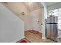 Bright foyer with tile flooring, staircase, neutral walls, and a view of the front door and stainless refrigerator at 1532 Andora Dr, Rock Hill, SC 29732