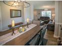 Elegant dining room with stylish furniture, chandelier, and view into the living space at 1600 Gaston Mountain Dr, Dallas, NC 28034