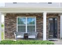 Inviting front porch with stone accents and comfortable seating for relaxing outdoors at 1600 Gaston Mountain Dr, Dallas, NC 28034