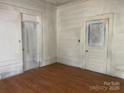 A bedroom featuring hardwood floors, white trim, and a closet awaiting finishing touches and customization at 169 Saluda St, Chester, SC 29706
