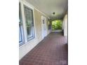 Tiled front porch features an open-air design with white trim, providing a great space for outdoor relaxation at 169 Saluda St, Chester, SC 29706