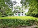 Picturesque home showcasing a grand facade, lush greenery, and mature trees, creating a serene setting at 206 Rose Ter, Wadesboro, NC 28170