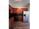Kitchen features cherry cabinets, black appliances, and a stainless steel refrigerator at 2125 Southend Dr # 320, Charlotte, NC 28203